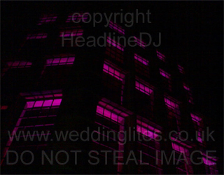 Pink uplighting windows viewed from outside at Hoghton Tower in Lancashire