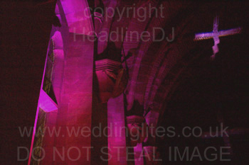 Uplighting tall stone carved windows at Peckforton Castle, Cheshire. Windows reach 6 meters from the floor.